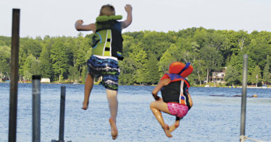 two kids jumping into the water